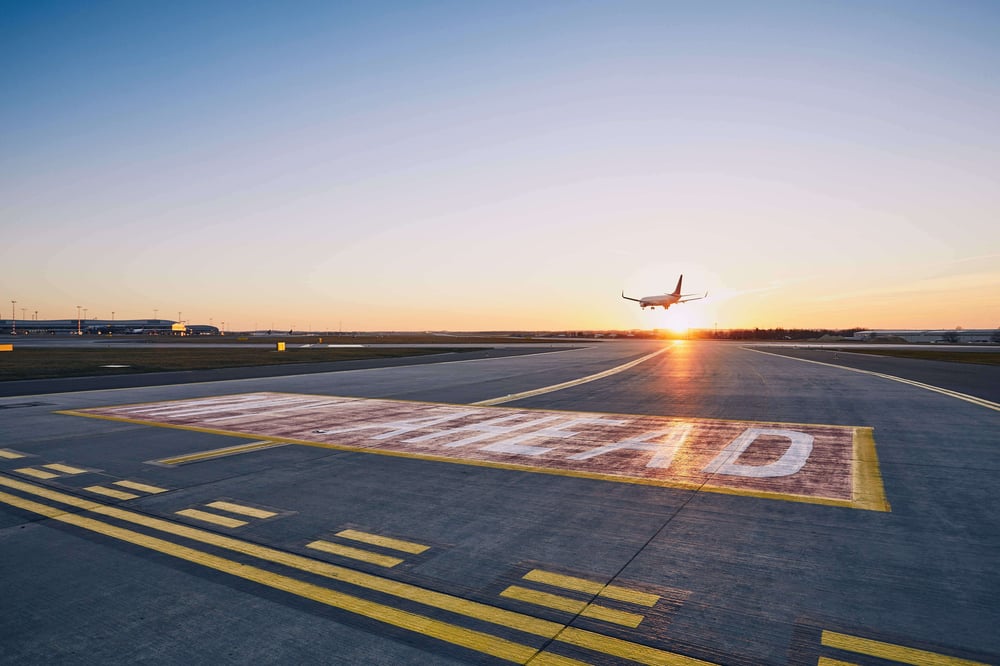 airplane-landing-at-sunset